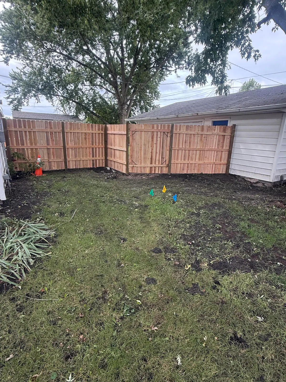 Cedar board-on-board privacy fence with a matching walk gate, built by Precision Fence Co.